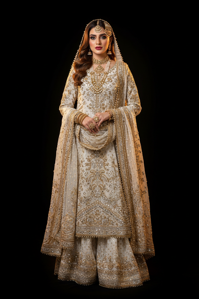 Model wearing Ivory Bridal Salwar Kameez with gold gota work