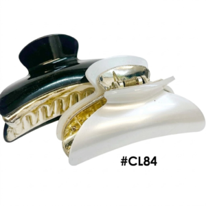Two stylish hair claw clips (item #CL84), with gold-tone metal teeth and hinges. The clip in the foreground has a glossy white marble finish, while the clip behind it has a glossy dark black finish, both on a pure white background.